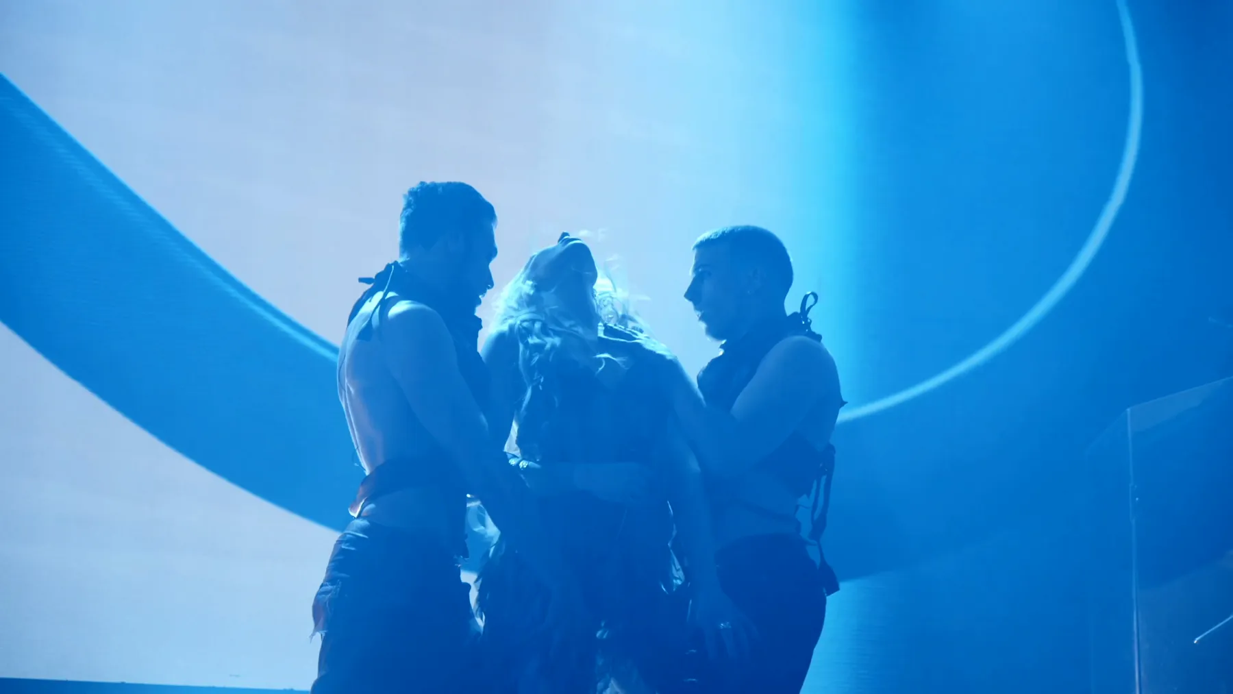KING IV and two dancers silhouetted against a blue screen