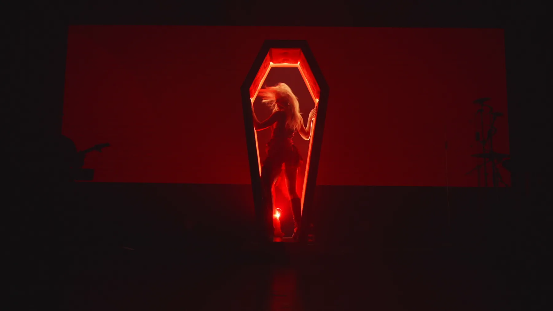 KING IV inside the glowing coffin portal on stage